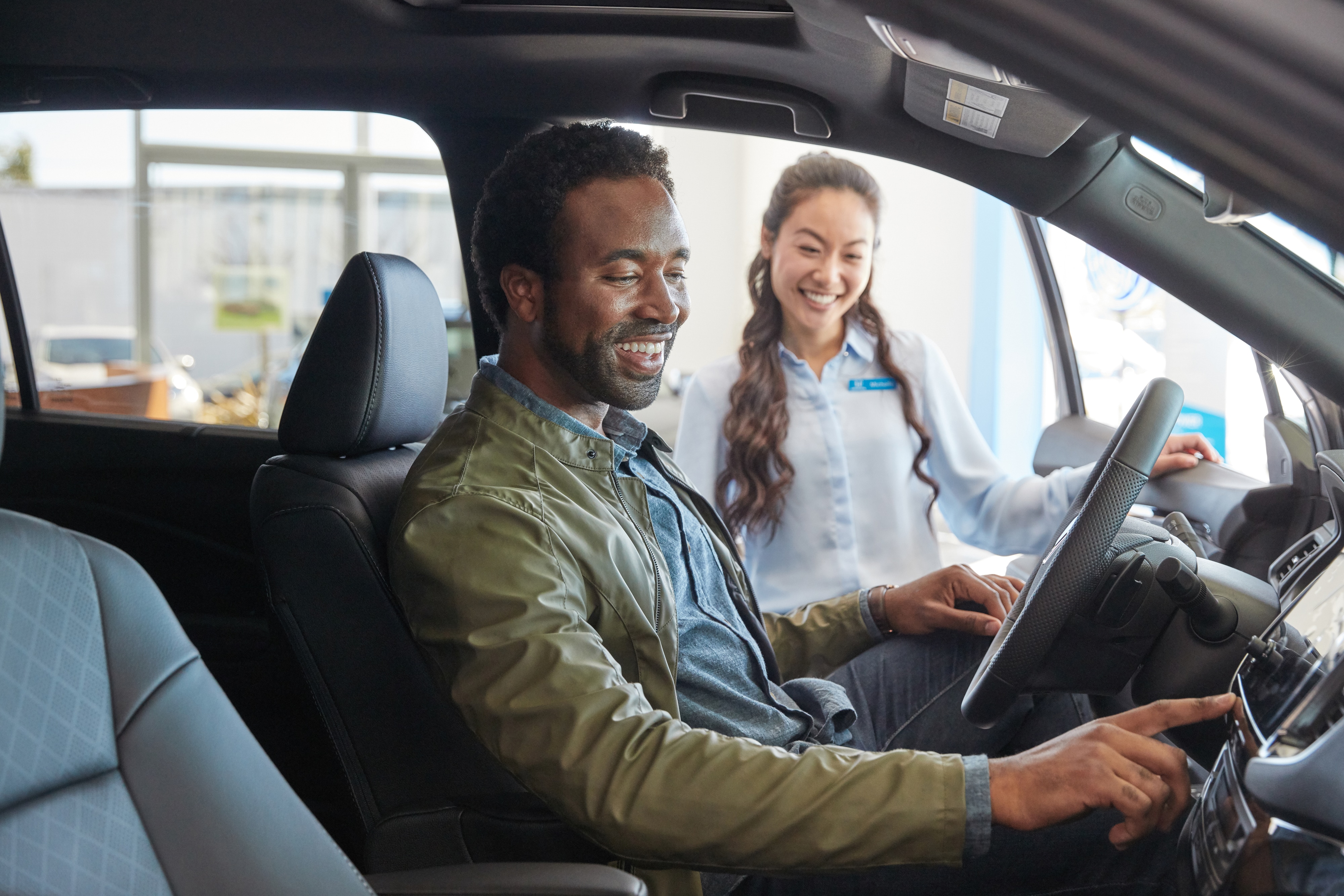 Sales advisor showing vehicle to customer